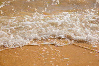 High angle view of waves rushing towards shore