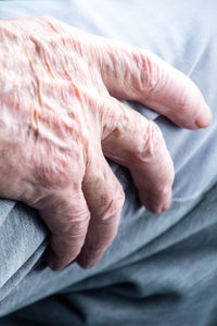 Close-up of woman hand on bed