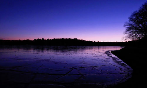 Scenic view of lake against clear sky during winter