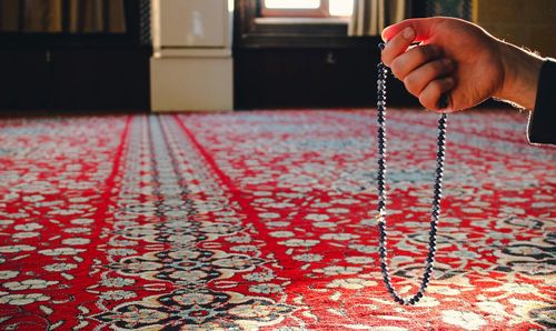 Close-up of person holding prayer bead