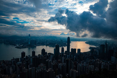 Aerial view of buildings in city against sky