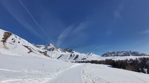 Snow covered mountain against blue sky