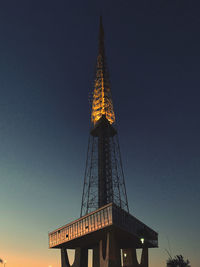 Low angle view of illuminated building against sky at night