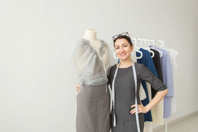 Smiling young woman standing in front of a store