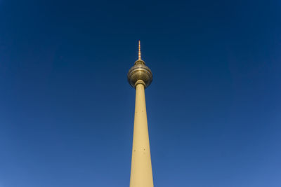 Low angle view of fernsehturm tv tower against blue sky