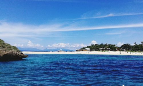 Scenic view of sea against blue sky