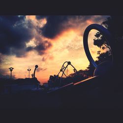 Silhouette of car against cloudy sky