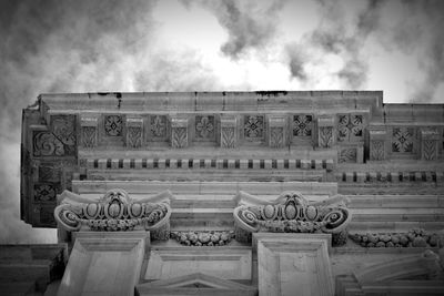 Low angle view of built structure against cloudy sky