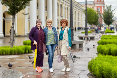 Portrait of people walking on footpath