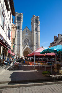 Buildings in city against clear blue sky
