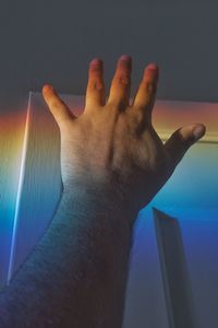 Close-up of hand against wall