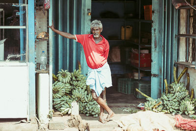 Woman standing by building