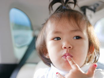 Close-up of baby girl in car