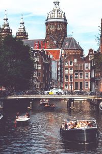 Boats in river with buildings in background