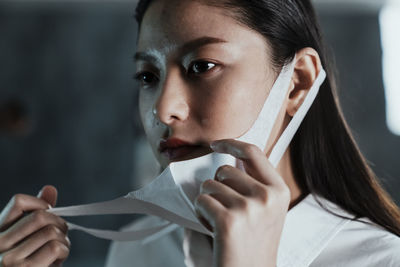 Close-up of young woman wearing mask