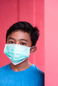 Portrait of boy against wall