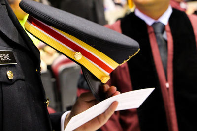 Cropped image of officer in uniform holding cap