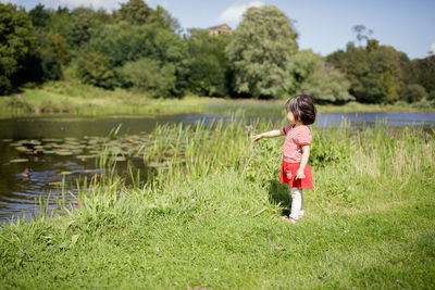 Side view of girl standing on grass