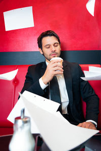 Young man sitting on table