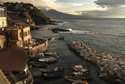 High angle view of buildings by sea against sky