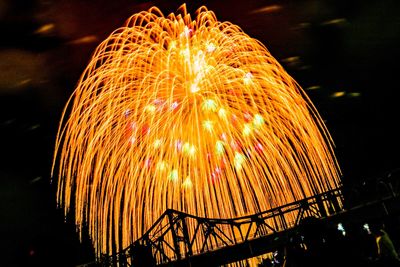 Low angle view of firework display at night