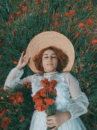 Full length of cute girl standing by plants on field