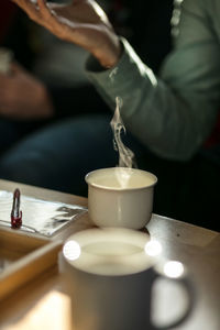 High angle view of coffee on table with people in background