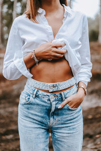 Midsection of woman standing on field