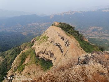 High angle view of land and mountains against sky