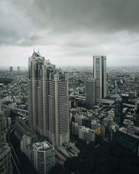 High angle view of modern buildings in city against sky