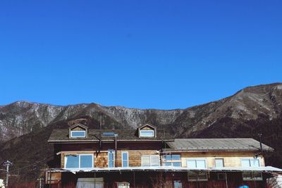 Built structure against mountains and clear blue sky