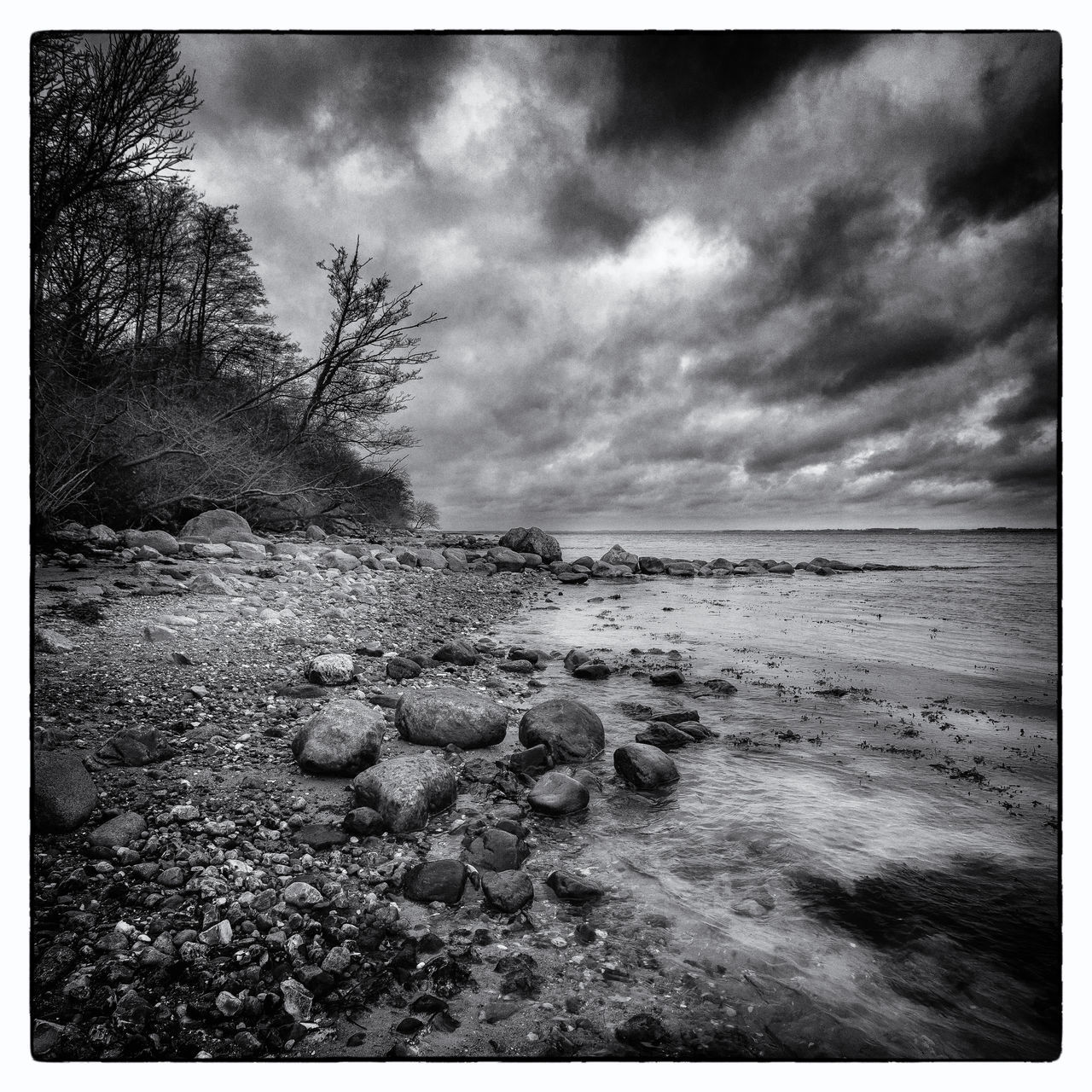 VIEW OF BEACH AGAINST CLOUDY SKY