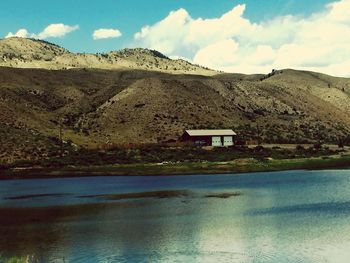 Scenic view of lake against cloudy sky