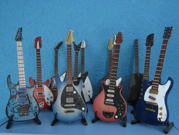 Colorful electric guitars against wall