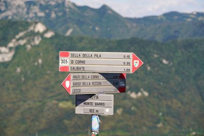 Close-up of signboards against blurred background