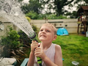 Portrait of smiling boy holding plant