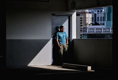 Full length of man standing against building in city