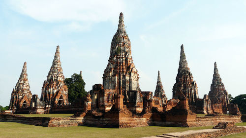 Stupas made mainly in bricks with green lawn surrounding. thailand colours of the past heritage
