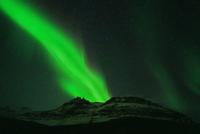 Scenic view of mountains against sky at night