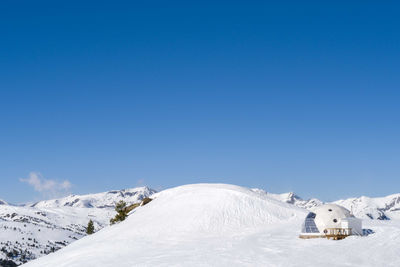 Snowy igloo on the mountain slope