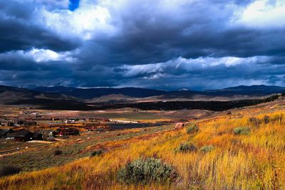 Scenic view of dramatic landscape against cloudy sky