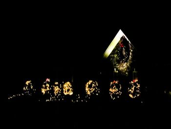 Illuminated fireworks against clear sky at night