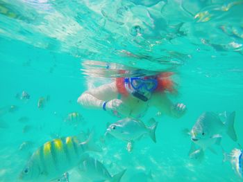 Young woman scuba diving undersea