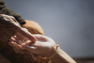 Close-up of couple holding hands