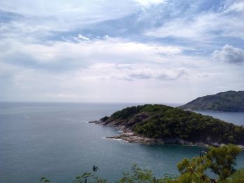 Scenic view of sea and mountains against sky