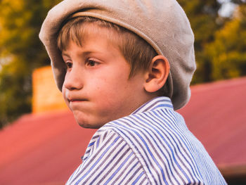 Close-up of thoughtful boy wearing flat cap