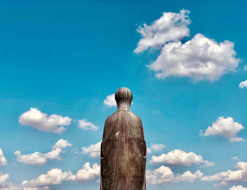 Low angle view of statue against blue sky