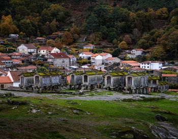 High angle view of houses by trees in town