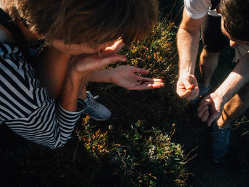 Low section of friends on grassy field