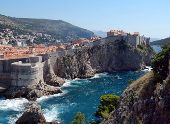 Panoramic view of sea and old town against clear sky